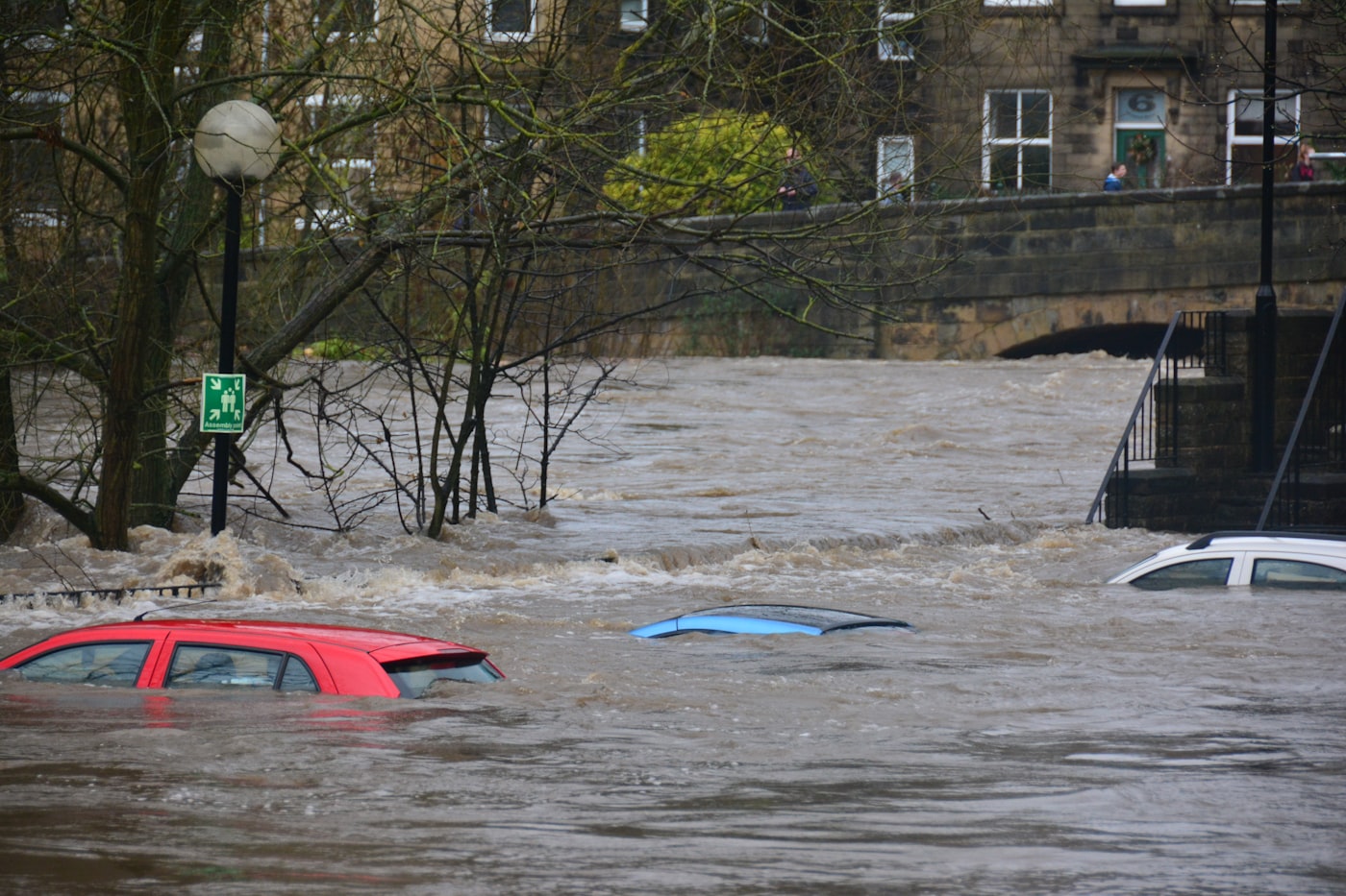 A flooded street with submerged cars, sealed live the moment it was captured